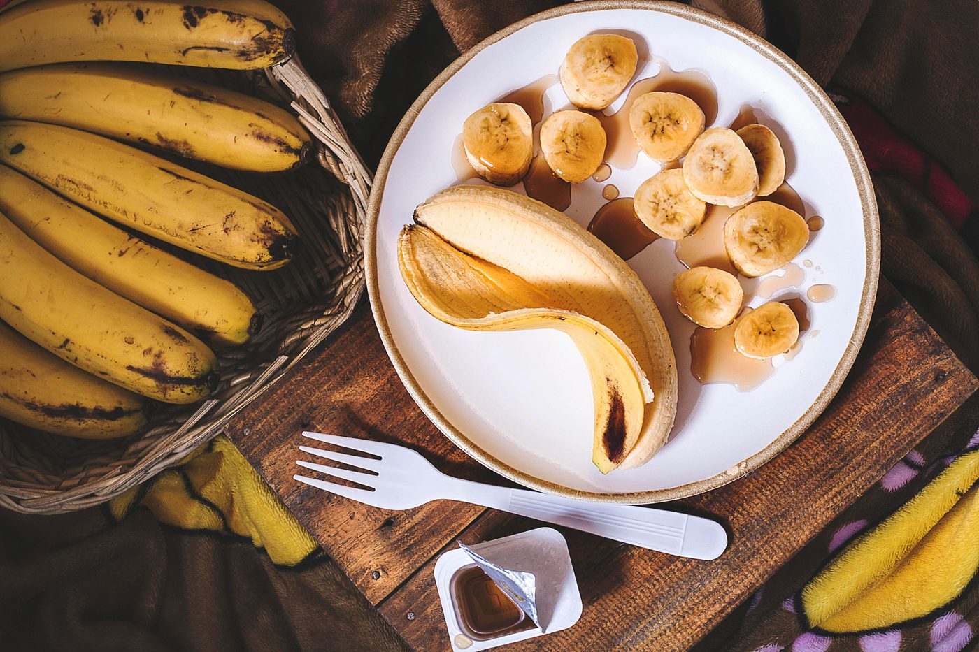 Sliced bananas on a plate drizzled with syrup