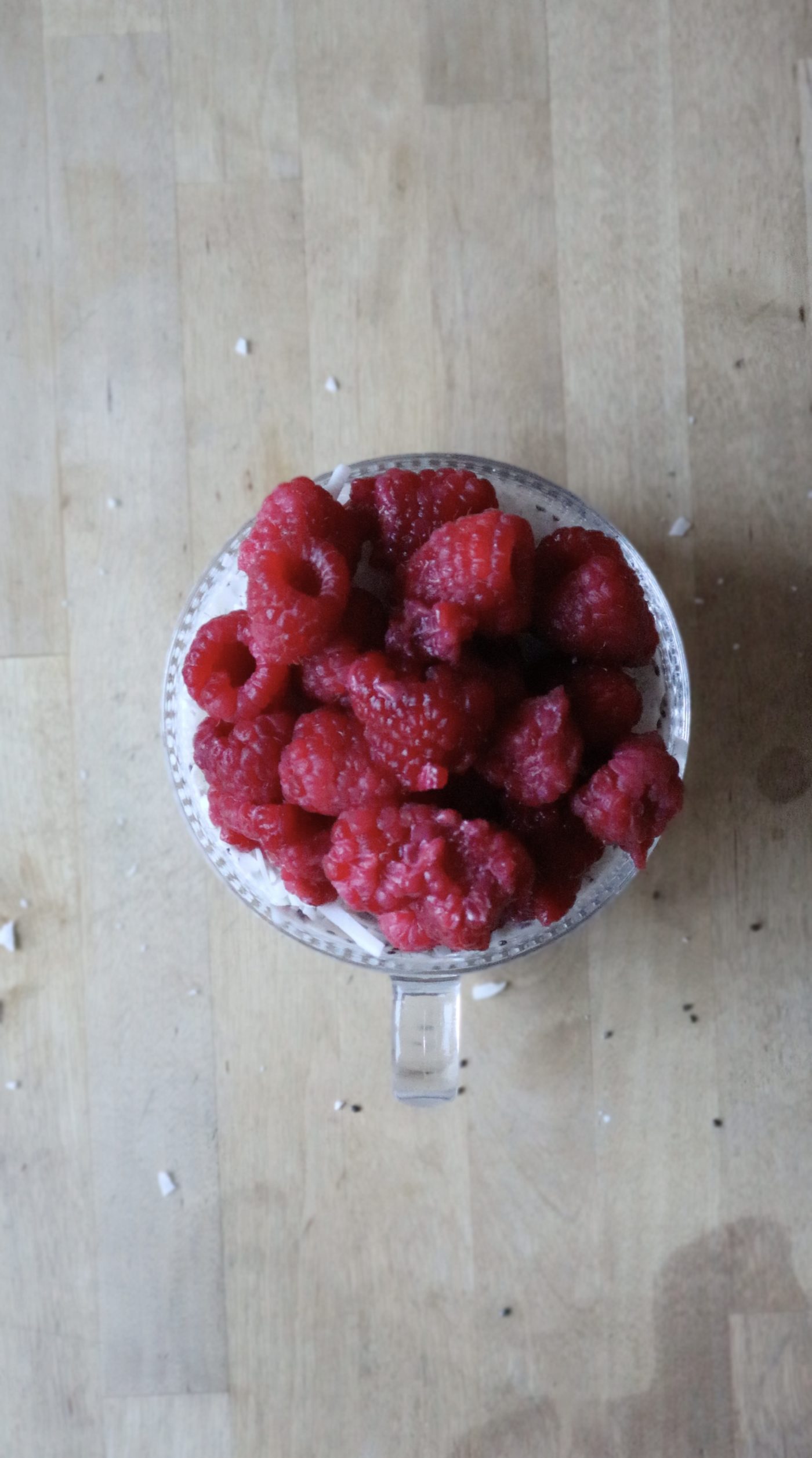 Fresh raspberries piled on top of chia seed parfait