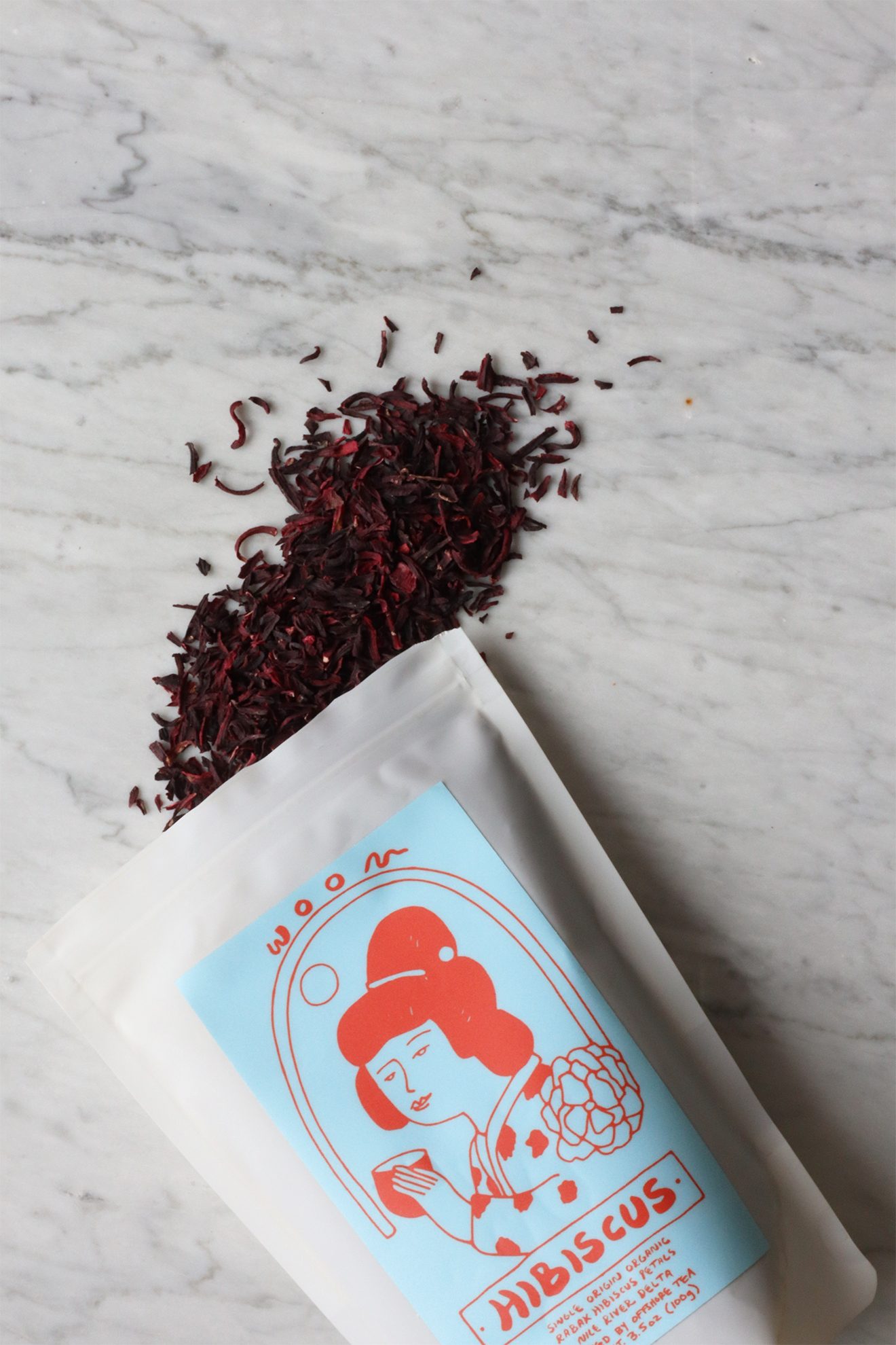 Dried hibiscus petals spilling from their packaging