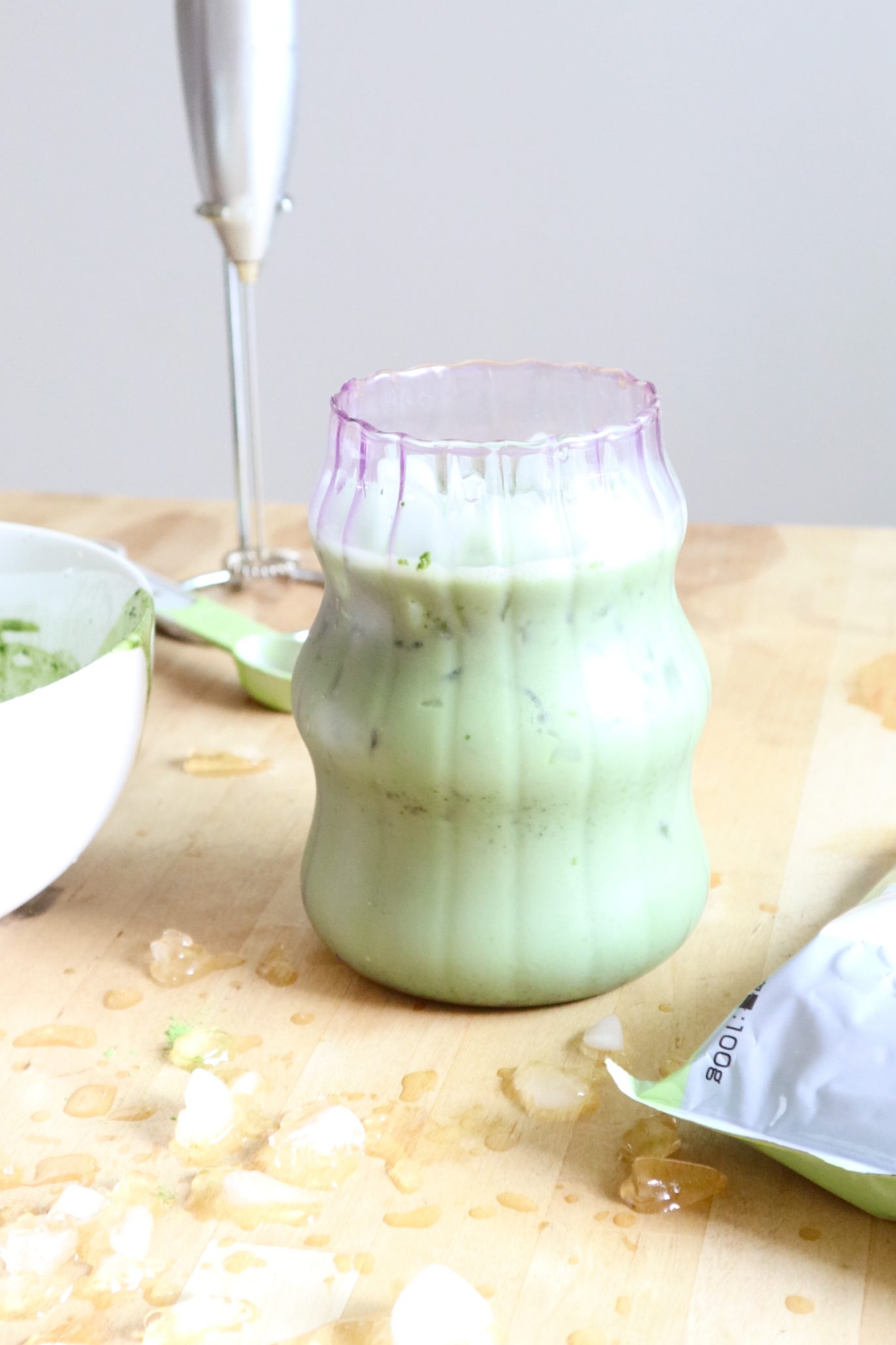 Matcha latte settling into layers in a glass