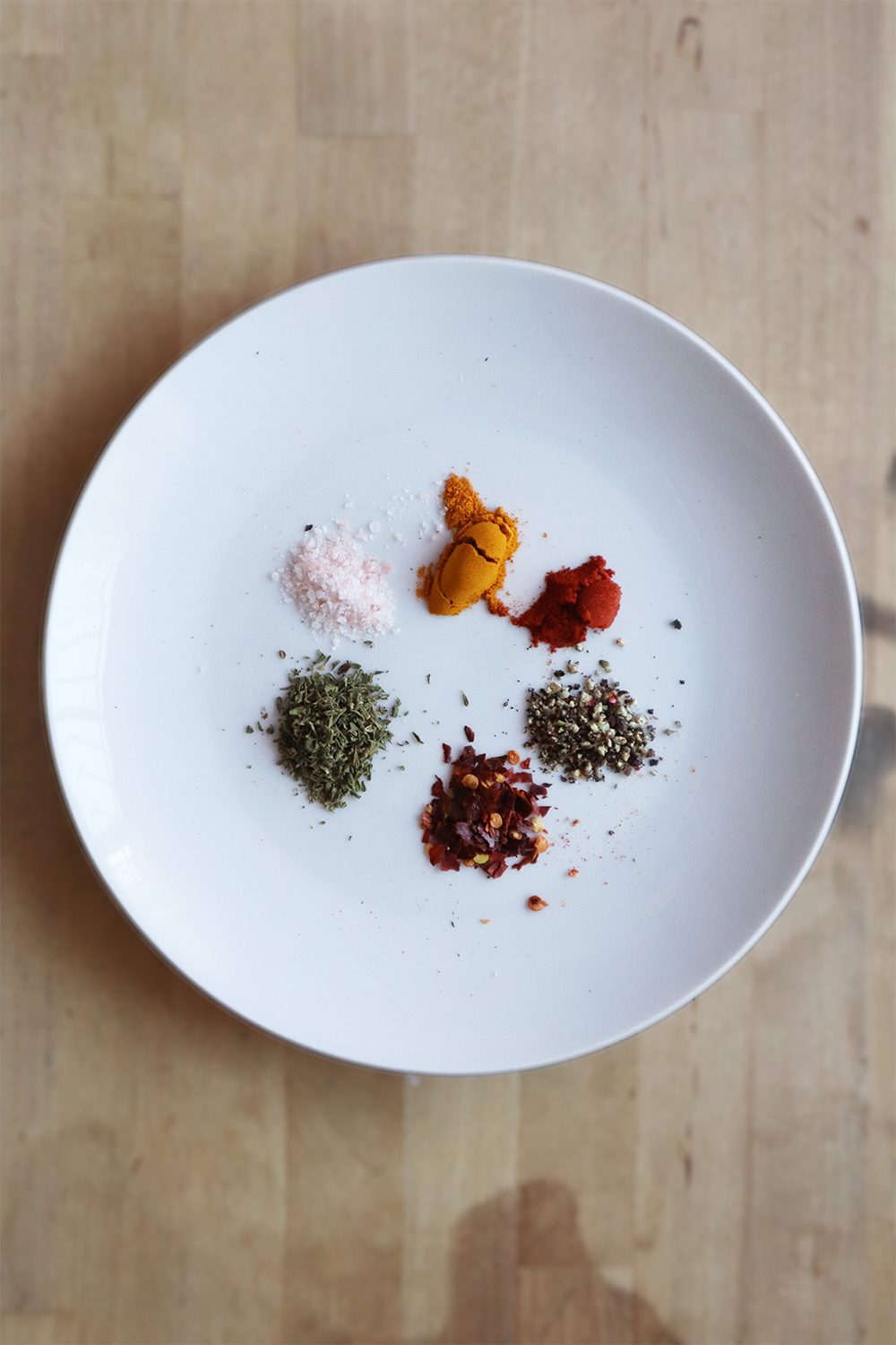 Spices for scrambled tofu measured out on a plate