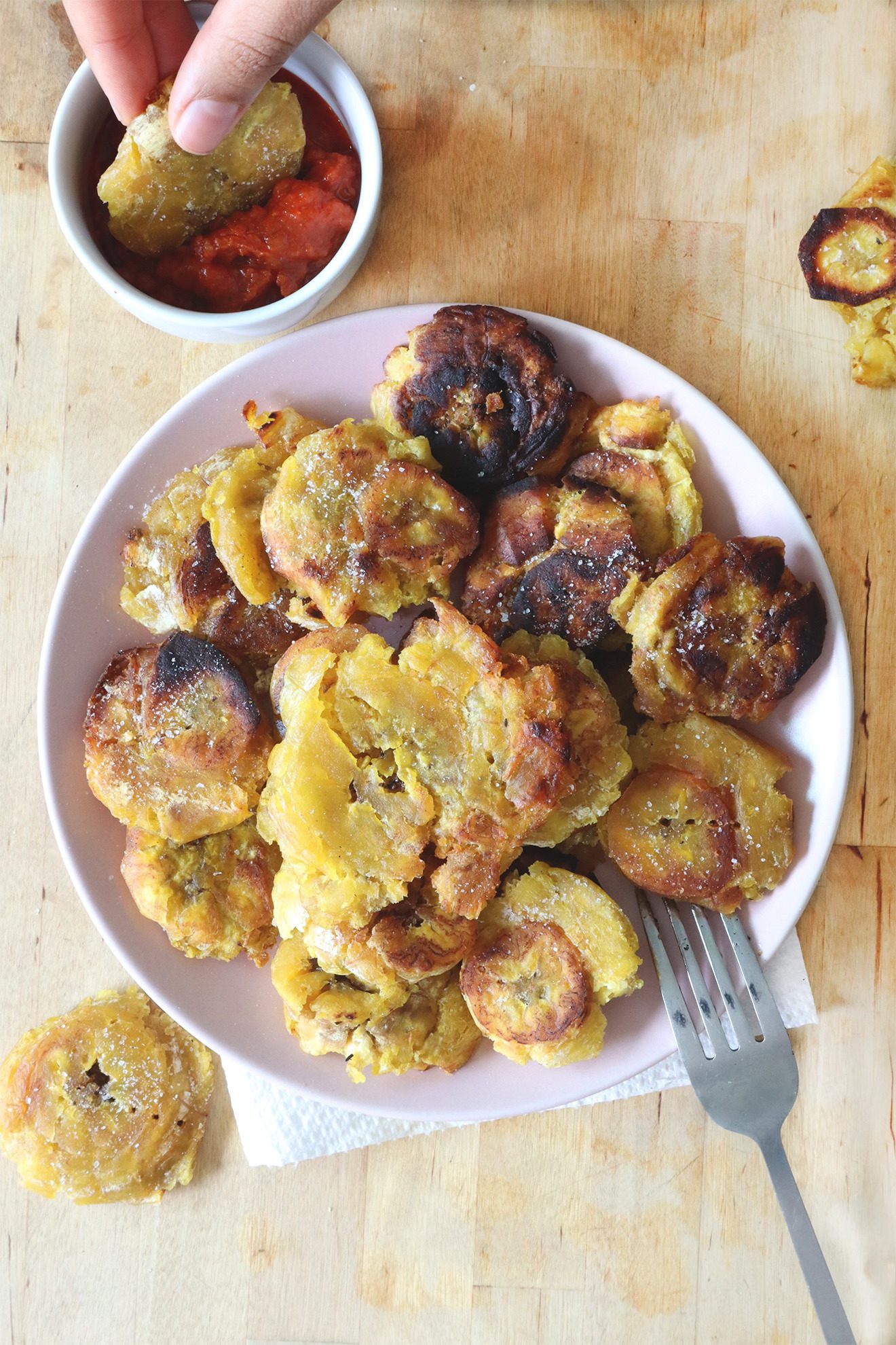 Tostones served with a dipping sauce on a plate