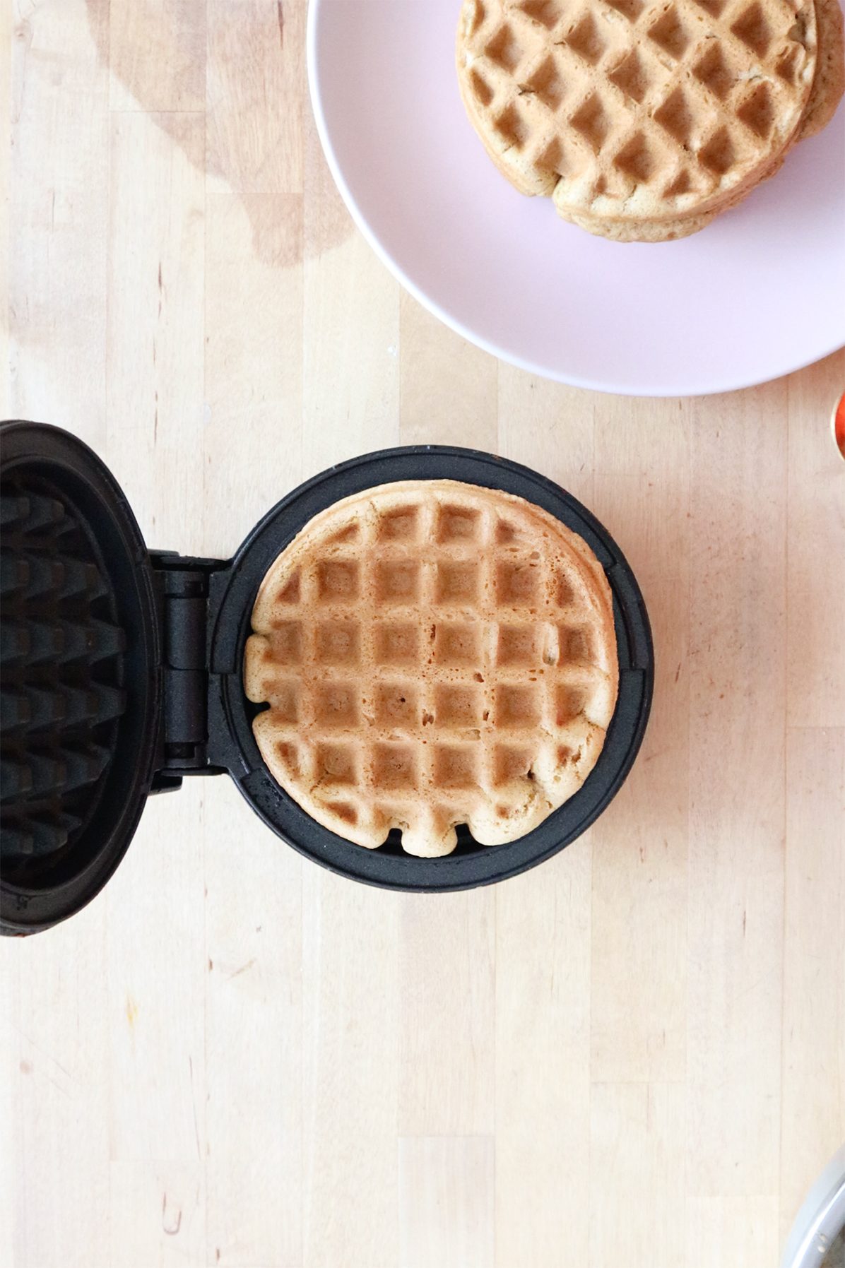 Waffle batter cooking in a mini waffle iron